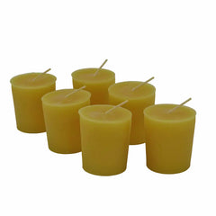 Six votive candles with white wicks, arranged in a cluster on a plain white background.