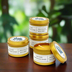 Gold tins with candles on a white background