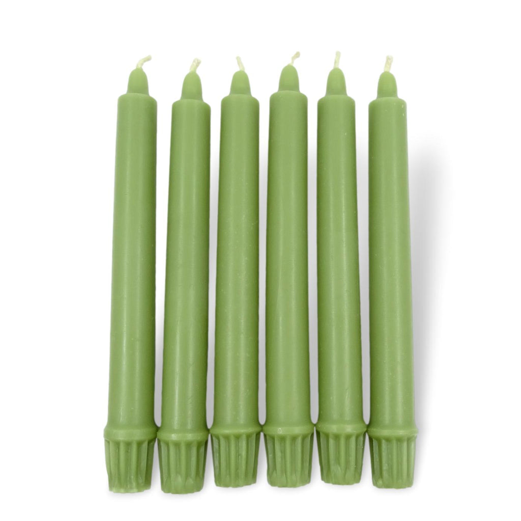 Set of green candles on a white background