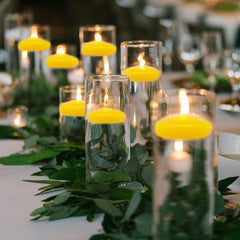 Decorative candles with leaves on a table setting
